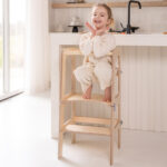 Jindl 2-in-1 leertoren houtkleuren poseren in de keuken