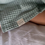Badcape | poncho Jindl lichtgroen detail logo